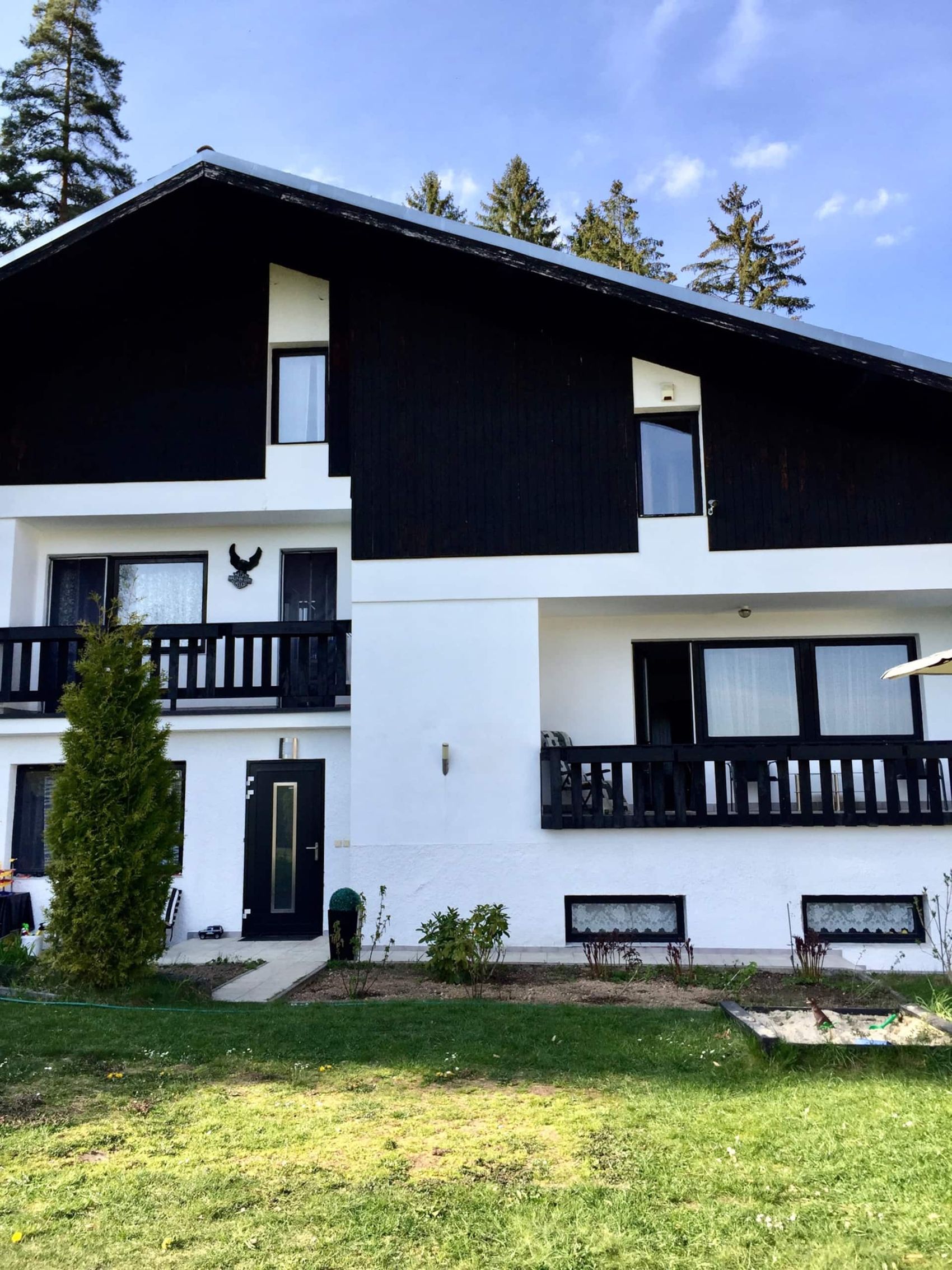 Bíločerný dům v lese, celá fasáda s balkony